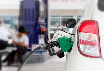 Close up of fuel monitoring system refueling a petroleum to vehicle at gas station.