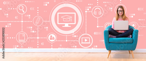 Foto E-Learning with young woman using her laptop in a chair