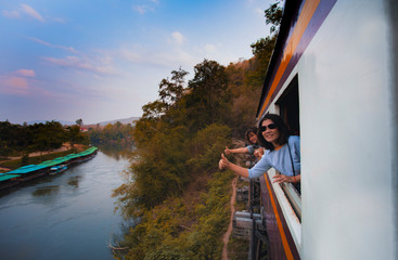 two asian woman traveling in kanchanaburi railway