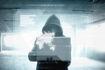 Wall Mural - Hacker in black hoodie holding laptop on the room