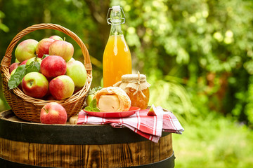 Poster - apples on background orchard standing on a barrel. Apple juice and apple preserves.