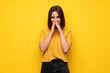 © luismolinero - Young woman over yellow wall smiling a lot