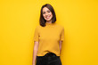 Leinwandbild Motiv Young woman over yellow wall smiling