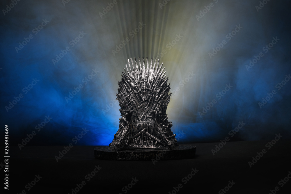 The model of throne as in Game of throne at a bright blue smoke background