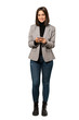 © luismolinero - A full-length shot of a Young business woman sending a message with the mobile over isolated white background