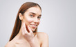 © proimagecontent - Long haired young female model girl touching her face skin cheeks hands fingers