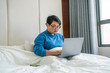 © Quang - Asian woman using laptop in hotel room