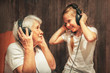 © Mariia Petrakova - old woman and little girl in headphones listening to music grandmother and granddaughter