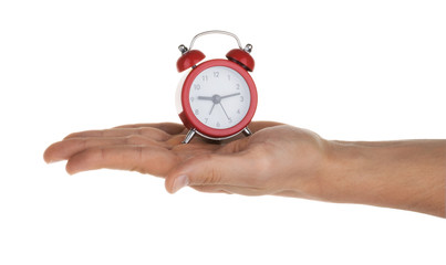 Hand holding alarm clock on white clipping path