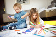 © Visual Intermezzo - Children are drawing with colorful crayons and having fun one with each other.