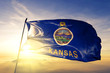 Kansas state of United States flag waving on the top sunrise mist fog