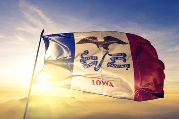 Poster - Iowa state of United States flag waving on the top sunrise mist fog