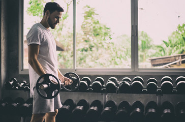 Portrait Caucasian handsome young man Are building muscles with exercise machines,healthy sports lifestyle, Fitness concept