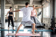 © kavee29 - Teamwork of young women and young man doing yoga exercises in gym concept healthy life fitness for slim