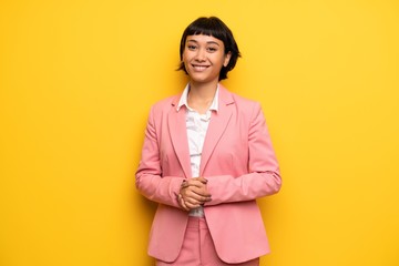 Wall Mural - Modern woman with pink business suit posing and laughing looking to the front