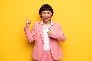 Wall Mural - Modern woman with pink business suit with surprise facial expression