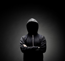 Wall Mural - Computer hacker in hoodie. Obscured dark face. Data thief, internet fraud, darknet and cyber security concept.