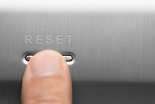 The Reset Button On The Aluminum Panel. Male Finger.