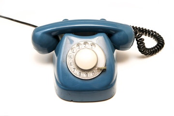 A blue old retro rotary mechanical phone isolated on a white background.