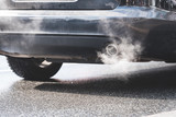 Fototapeta Sawanna - exhaust gas coming out of an exhaust pipe of a car on a street