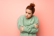 © luismolinero - Young redhead woman with sweatshirt freezing