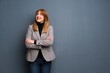 © luismolinero - Redhead business woman looking up while smiling