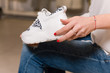 © o_lypa - Close-up of girl hold white casual sneakers