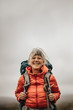 © Jacob Lund - Close up of a smiling female hiker standing outdoors