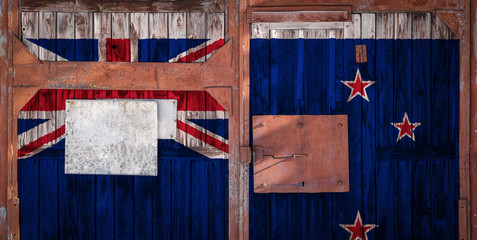 Close-up of old warehouse gate with national flag of New zealand. The concept of export-import New Zealand, storage of goods and national delivery of goods. Flag in grunge style