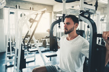 Handsome Man Is Exercising With Pectoral Machine In Fitness Club.,Portrait Of Strong Man Doing Working Out Calories Burning In Gym., Healthy And Fitness Lifestyle Concept.
