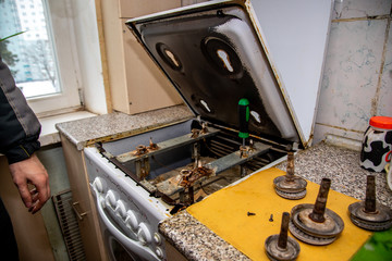 MINSK, BELARUS - 18 FEBRUARY, 2019: gas worker checks the gas stove