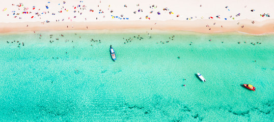 Poster - View from above, stunning aerial view of a beautiful tropical beach with white sand and turquoise clear water, long-tail boat and people sunbathing, Surin beach, Phuket, Thailand.
