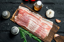 Raw Bacon With Rosemary Branches.