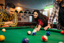 Billiard Players With Cues At The Table With Balls
