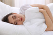 © rogerphoto - Beautiful young woman sleeping while lying in her bed. Concept of pleasant and rest reinstatement for active life