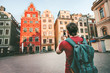 © EVERST - Man tourist sightseeing Stockholm city Gamla Stan landmarks traveling lifestyle girl taking photo by smartphone Europe trip summer vacations