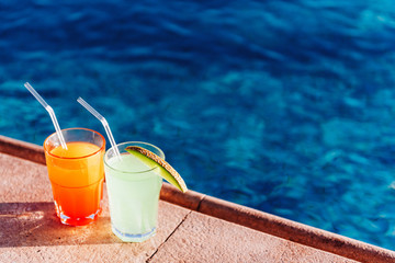 two cocktails by the pool