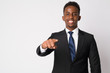 Portrait of happy young African businessman pointing at camera