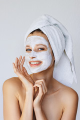 Wall Mural - beautiful young woman applying facial mask on her face. skin care and treatment, spa, natural beauty