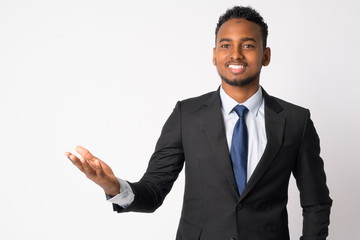 Wall Mural - Happy young handsome African businessman showing something