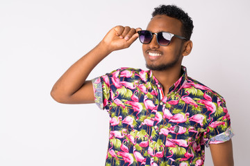 Poster - Happy young handsome African tourist man thinking with sunglasses