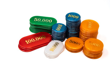 Stack of chips, isolated on white background. Colors: ivory, orange, blue, green, red. Betting, winning and losing at gambling. Play poker with fiches.