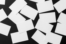 Top View Mockup Of White Horizontal Business Cards Scattered At Black Textured Paper Background.
