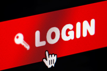 login button of a membership website being clicked. close up of a computer screen.