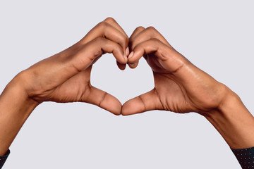 Afro American hand make heart shape.