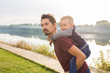 © satura_ - Fatherhood and children concept - Father holding his little son on nature