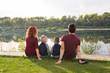 © satura_ - Children, parenthood and nature concept - Big family sitting on the grass
