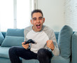 © SB Arts Media - Close up portrait of young man playing video game having fun, In video game addiction or leisure