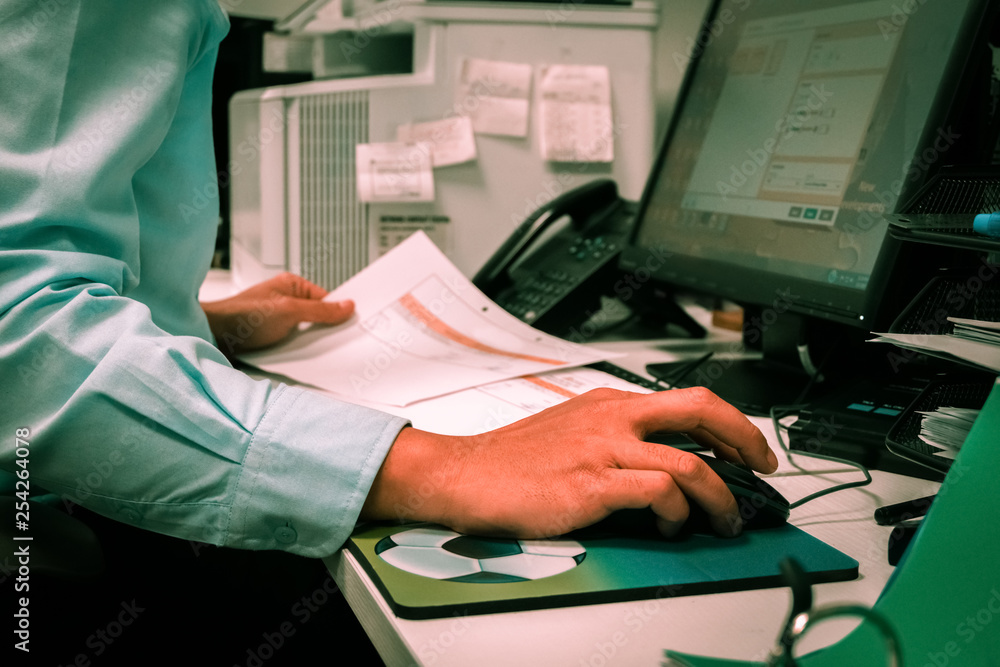 Hardworking male employee working in the office.-Typical busy scene in ...