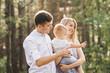 © ksyusha_yanovich - Happy young family spends time together in nature.